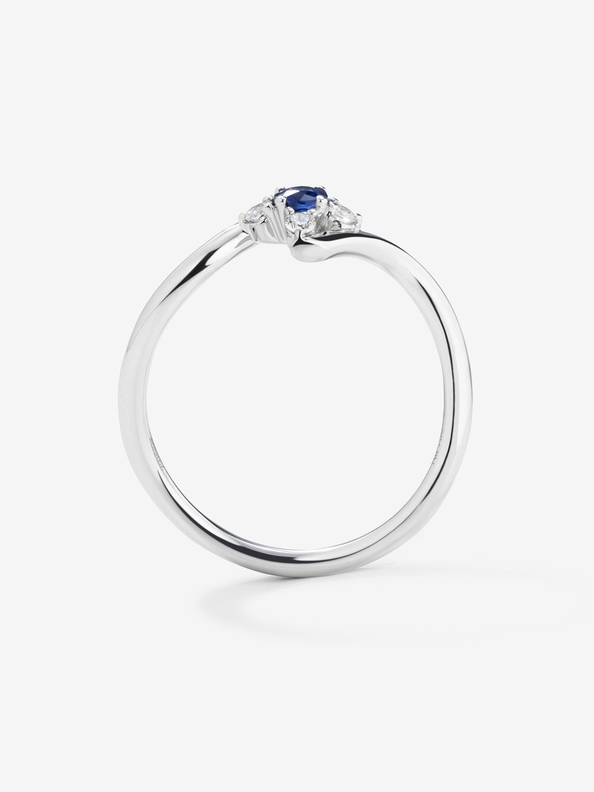 Anillo de oro blanco de 18K con zafiro azul en talla brillante de 0,15 y 4 diamantes en talla brillante con un total de 0,08 cts