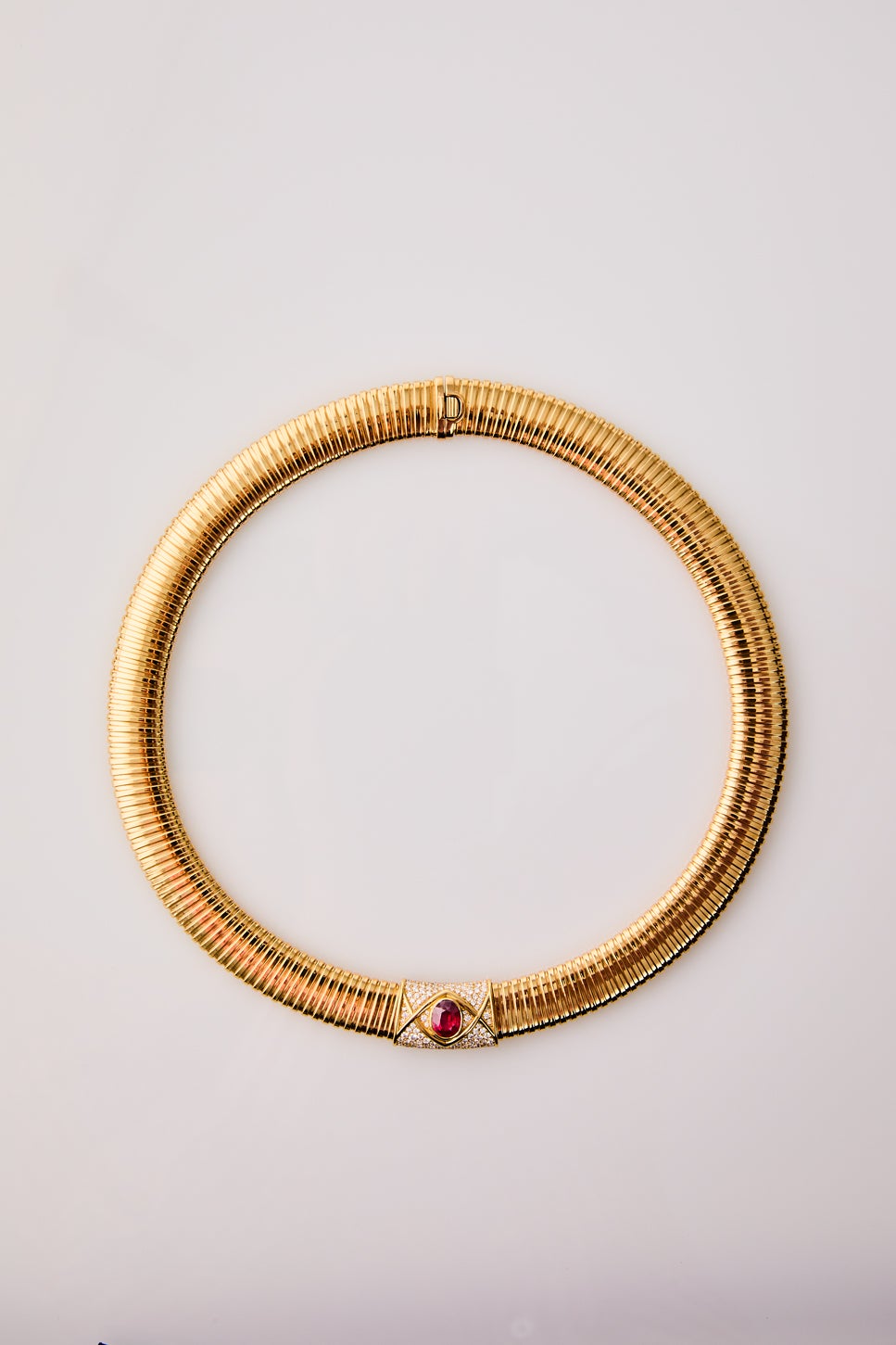 Collar tubogas de oro amarillo de 18K con rubí rojo pigeon blood en talla oval de 2,4 cts y 116 diamantes en talla brillante con un total de 1,4 cts