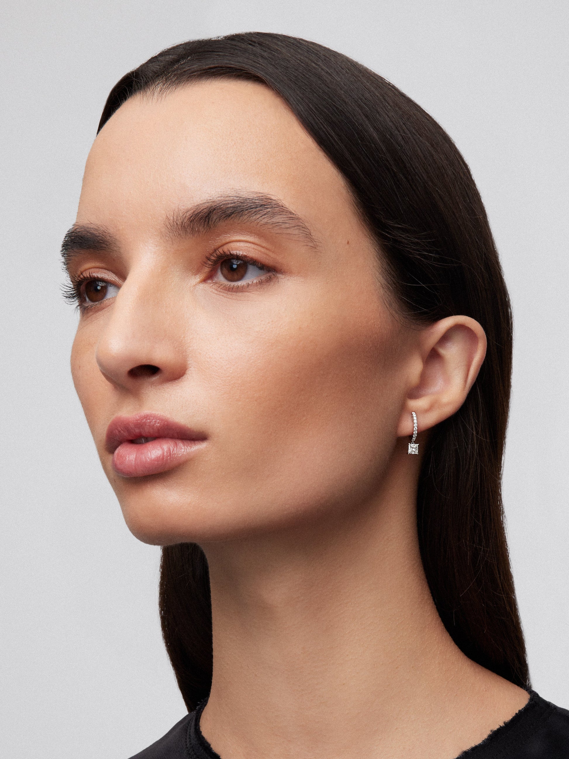 Pendientes de aro de oro blanco de 18K con dos diamantes en talla princesa con un total de 0,6 cts y 20 diamantes en talla brillante con un total de 0,19 cts