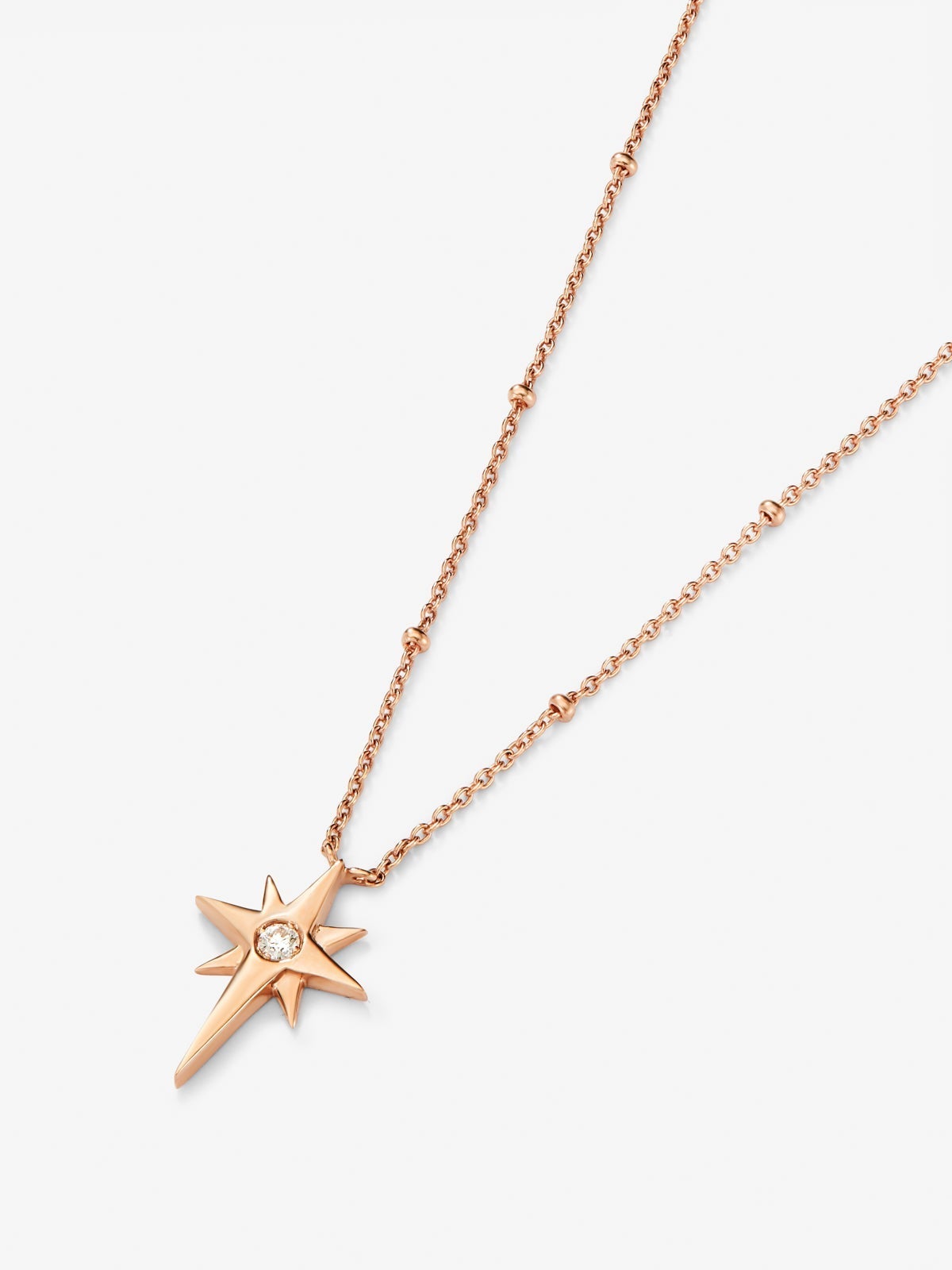 Colgante cadena con estrella de oro rosa de 18K con diamante