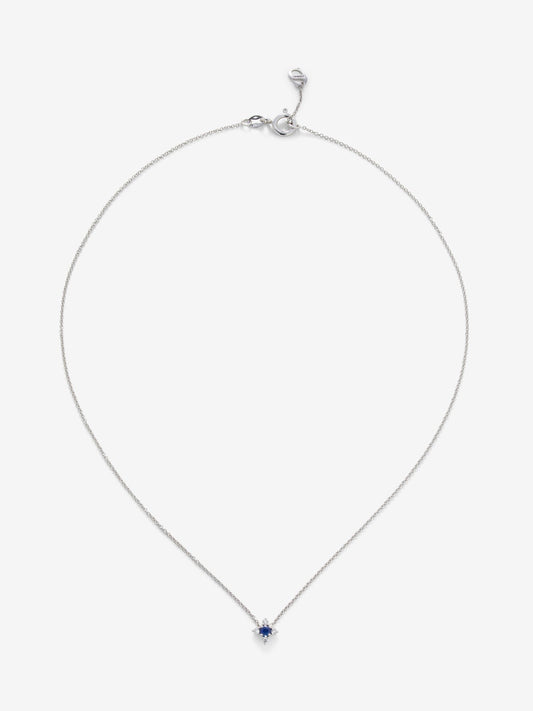 Colgante de oro blanco de 18K con un zafiro azul en talla brillante de 0,12 cts y 4 diamantes en talla brillante con un total de 0,08 cts