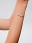 Pulsera rígida de oro blanco de 18K con 11 diamantes en talla brillante con un total de 0,2 cts