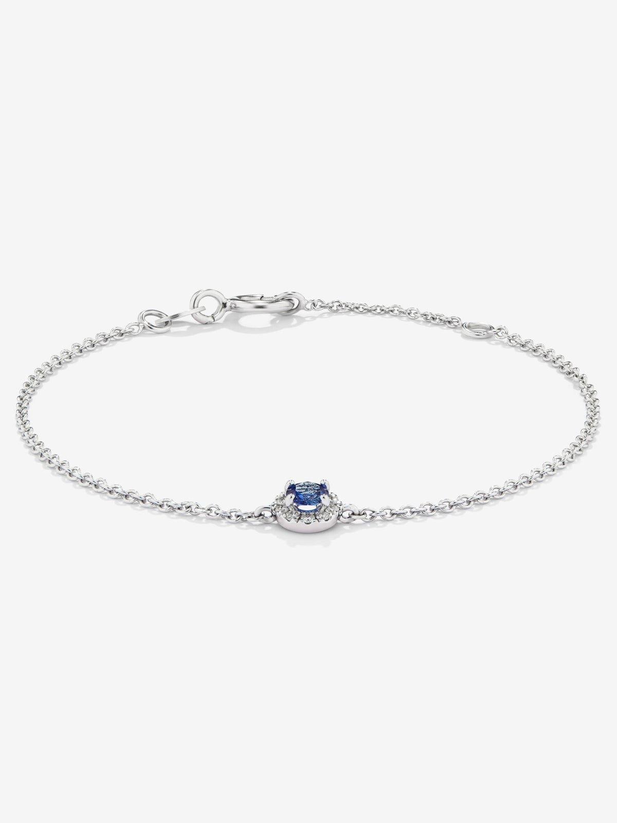 Pulsera de oro blanco de 18K con 10 diamantes en talla brillante con un total de 0,06 cts y un zafiro azul en talla brillante de 0,25 cts