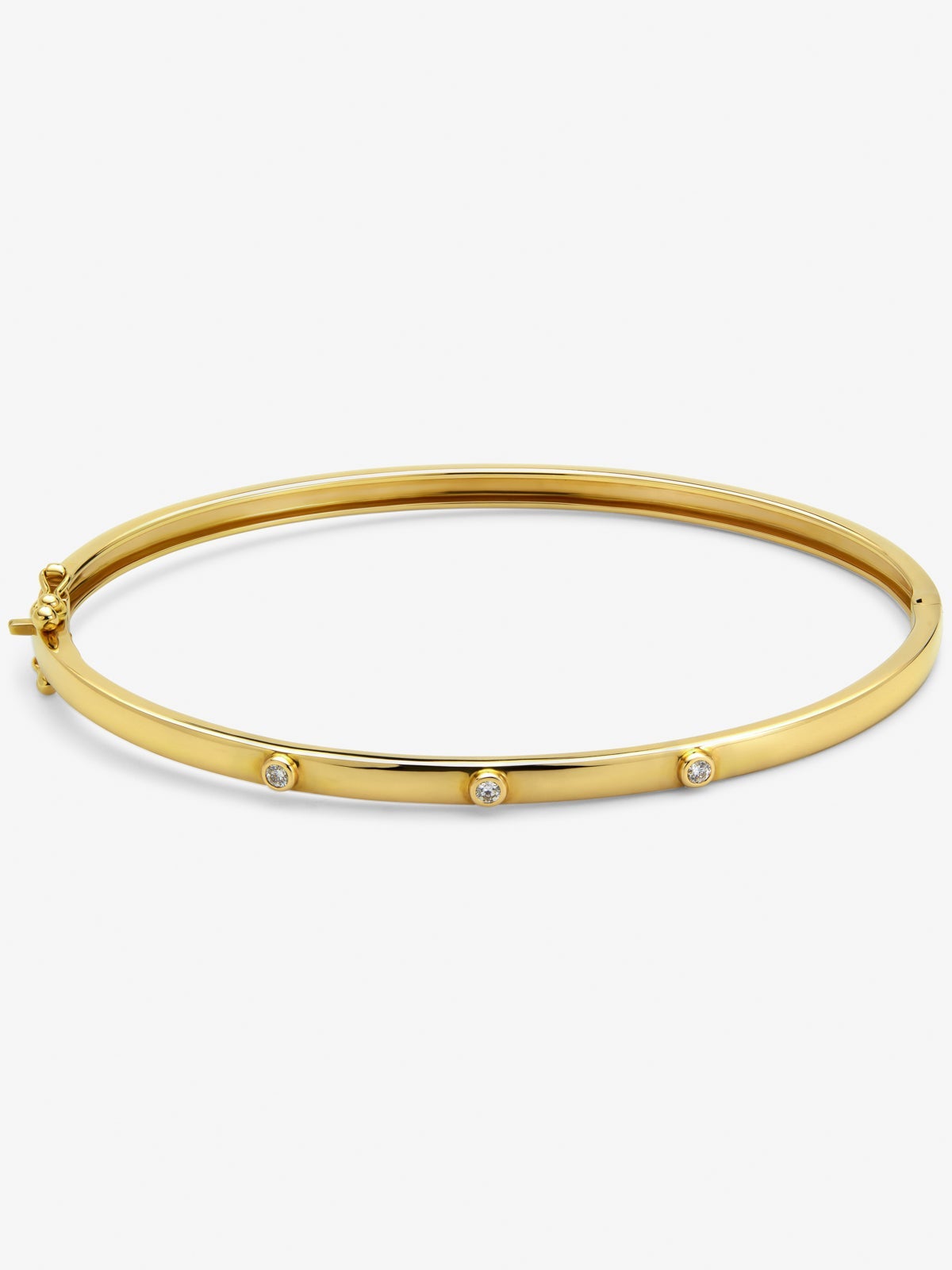 Pulsera rígida de oro amarillo de 18K con 3 diamantes en talla brillante con un total de 0,07 cts