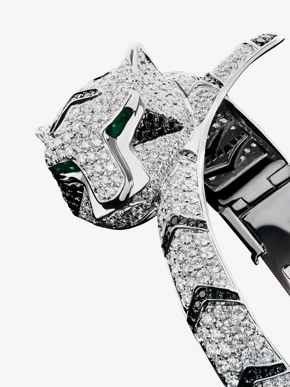 Rigid 18K white gold bracelet with 747 brilliant-cut white diamonds with a total of 8.17 cts, 241 brilliant-cut black diamonds with a total of 1.49 cts and 2 trapezoid-cut emeralds with a total of 0.13 tiger shaped cts
