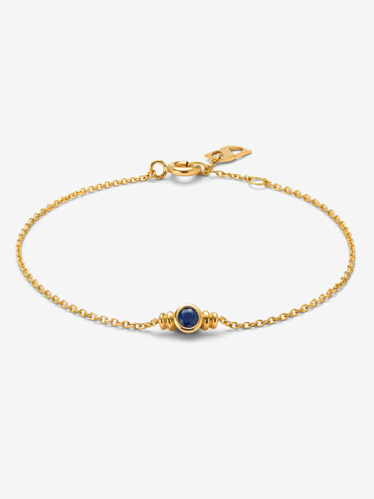 Pulsera de oro amarillo de 18K con zafiro azul en talla brillante de 0,15 cts