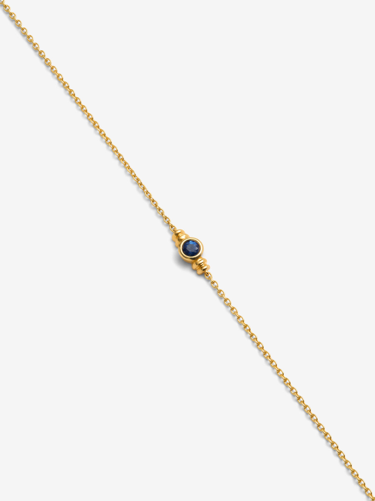 Pulsera de oro amarillo de 18K con zafiro azul en talla brillante de 0,15 cts
