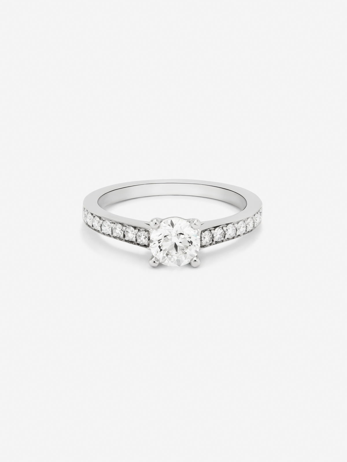 18K white gold solitaire ring with a 0.3 ct central diamond and a band of 18 brilliant-cut diamonds totaling 0.13 cts.