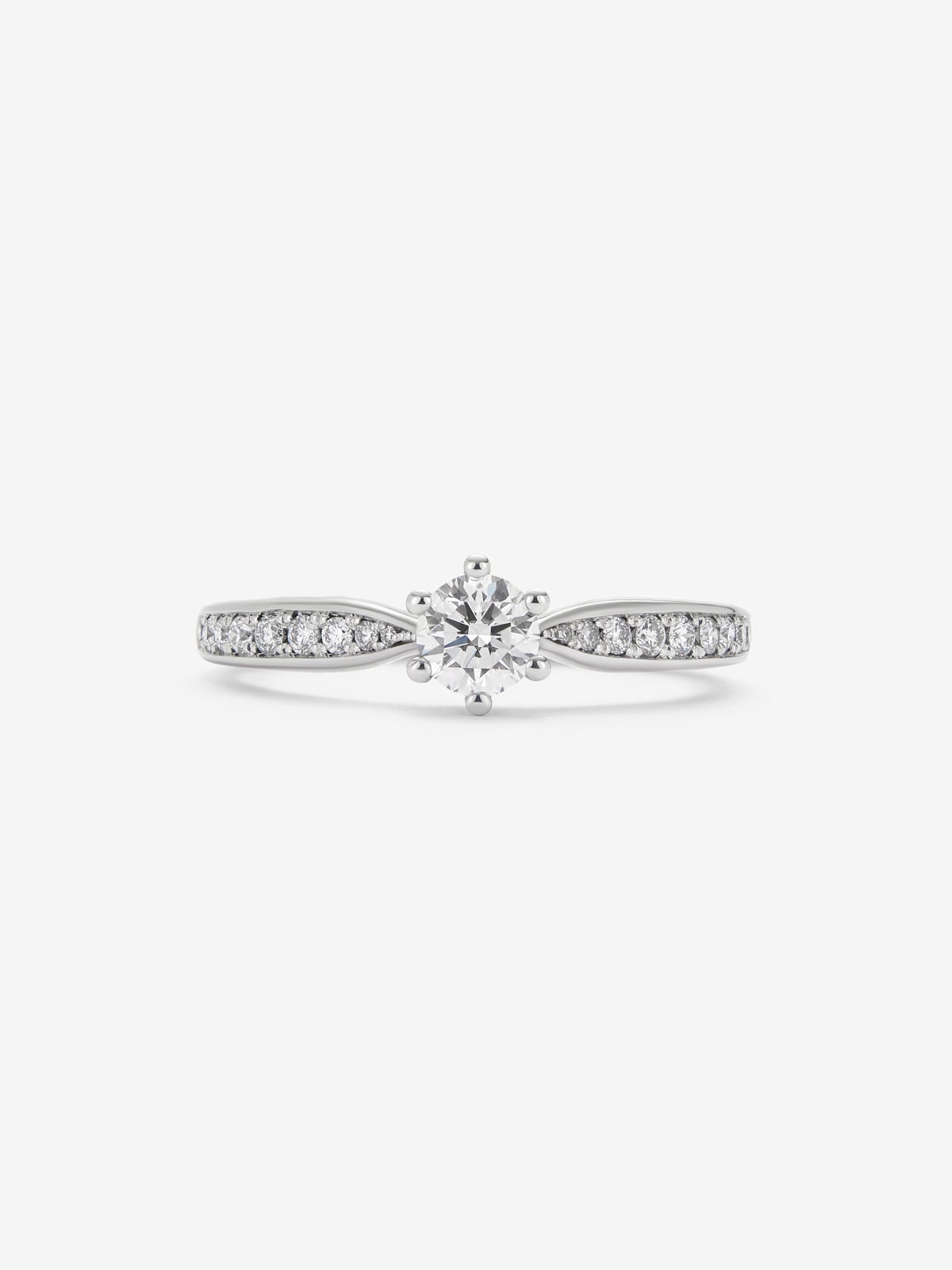 Anillo solitario de oro blanco de 18K con diamante central en talla brillante de 0,30 cts y diamantes en talla brillante con un total de 0,13 cts