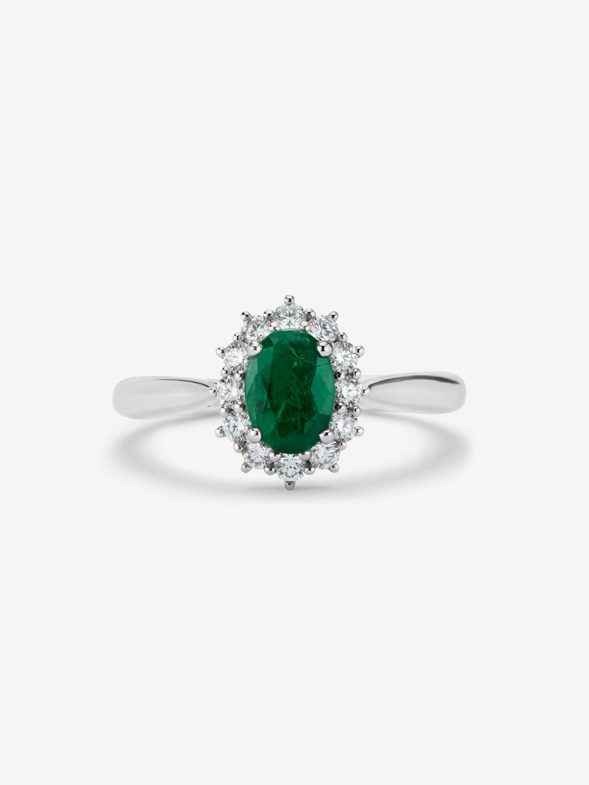 Anillo de oro blanco de 18K con esmeralda central en talla oval de 0,76 cts y orla de diamantes en talla brillante con un total de 0,45 cts
