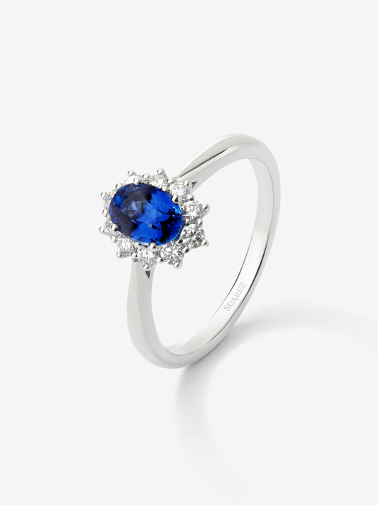 Anillo de oro blanco de 18K con zafiro azul central en talla oval de 0,4 cts y orla de diamantes en talla brillante con un total de 0,25 cts