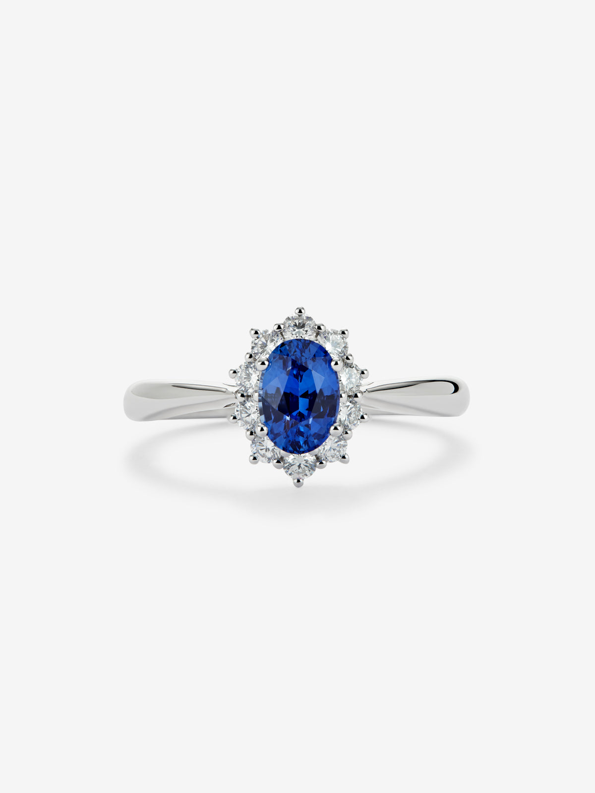 18K white gold ring with a central oval-cut blue sapphire of 0.4 cts and a border of brilliant-cut diamonds totaling 0.25 cts.