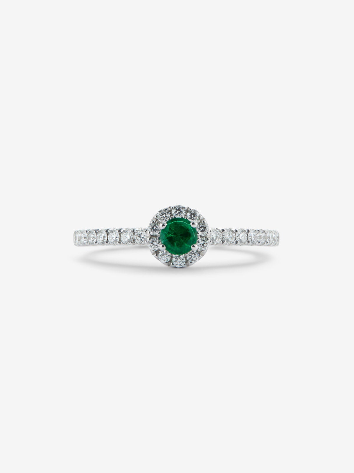 Anillo de oro blanco de 18K con esmeralda en talla brillante de 0,1 cts y brazo y orla de diamantes en talla brillante con un total de 0,20 cts
