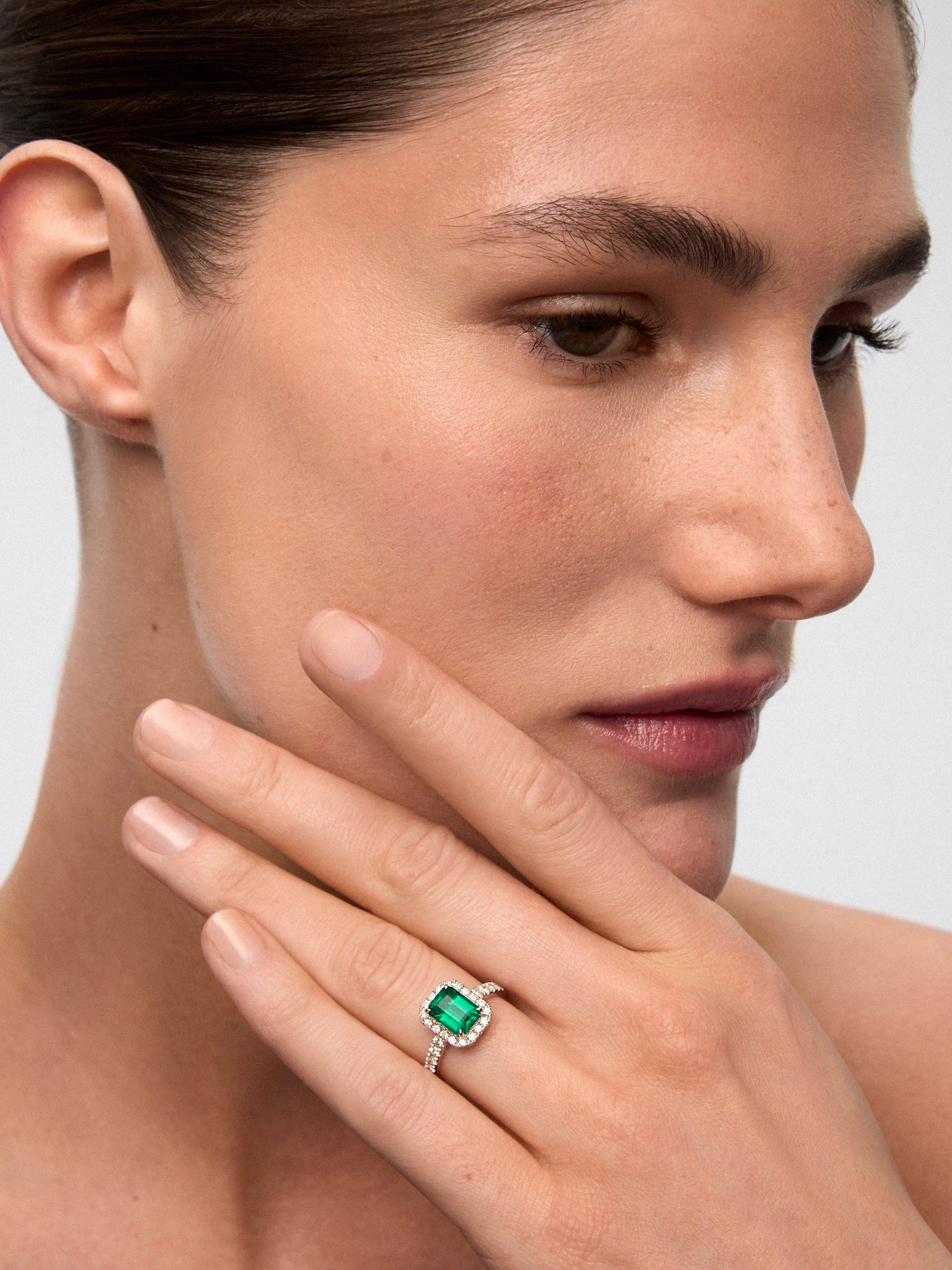 Anillo de oro blanco de 18K con esmeralda verde en talla octogonal de 1,67 cts y orla y brazo de 30 diamantes en talla brillante con un total de 0,43 cts