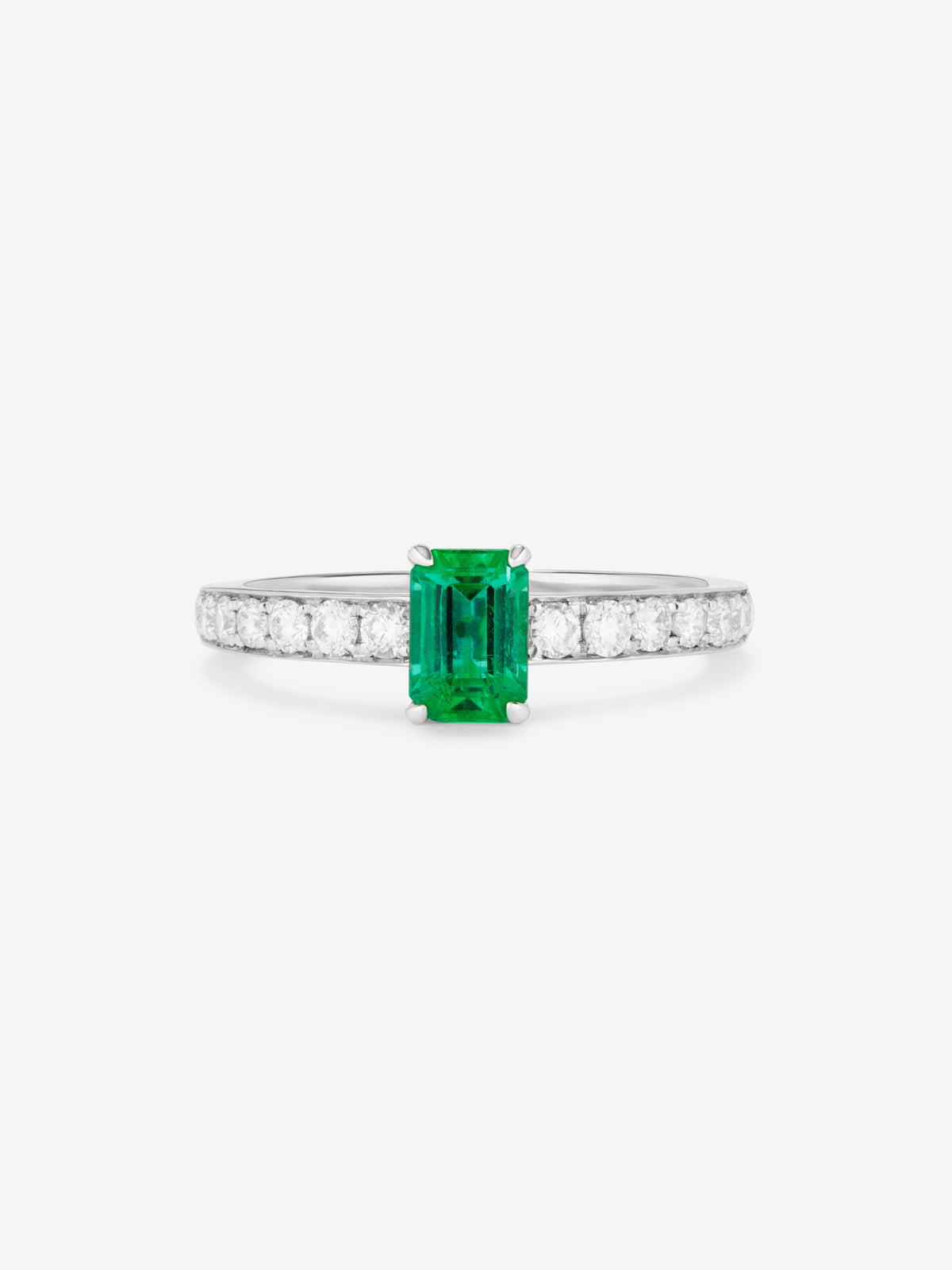 Anillo de oro blanco de 18K con esmeralda verde en talla esmeralda de 0,4 cts y diamantes en talla brillante de 0,18 cts
