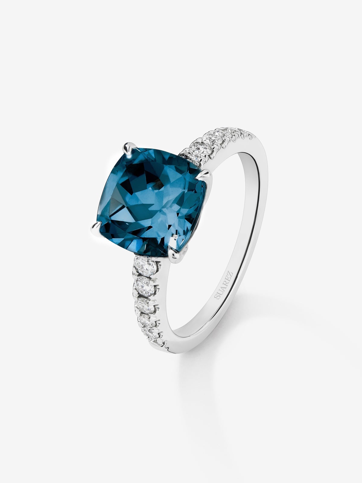 Anillo de oro blanco de 18K con topacio azul london en talla cushion de 3,8 cts y 12 diamantes en talla brillante con un total de 0,29 cts