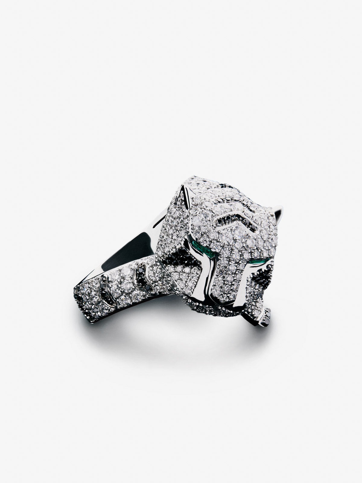18K white gold ring with 278 brilliant-cut white diamonds with a total of 1.87 cts, 55 brilliant-cut black diamonds with a total of 0.25 cts, and 2 trapezoid-cut emeralds with a total of 0.13 tiger shaped cts