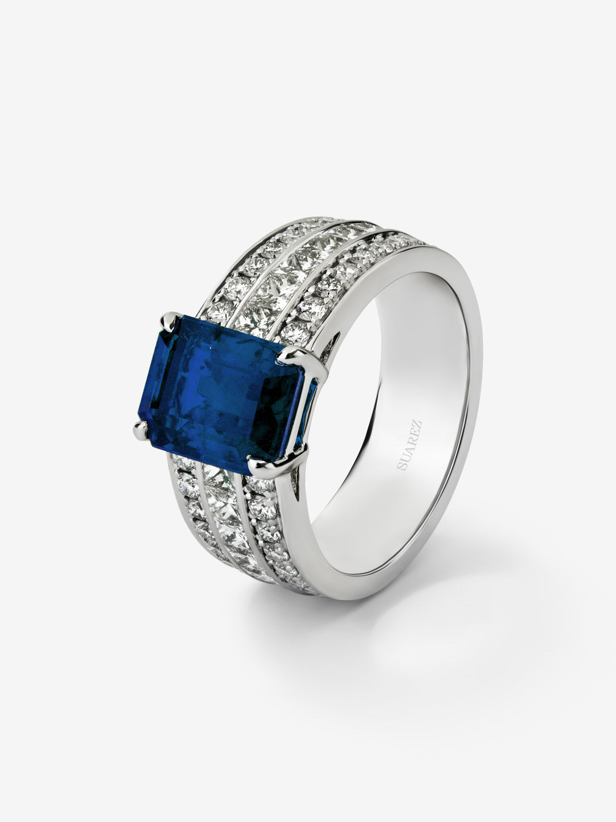 White gold ring with central sapphire and diamond arm
