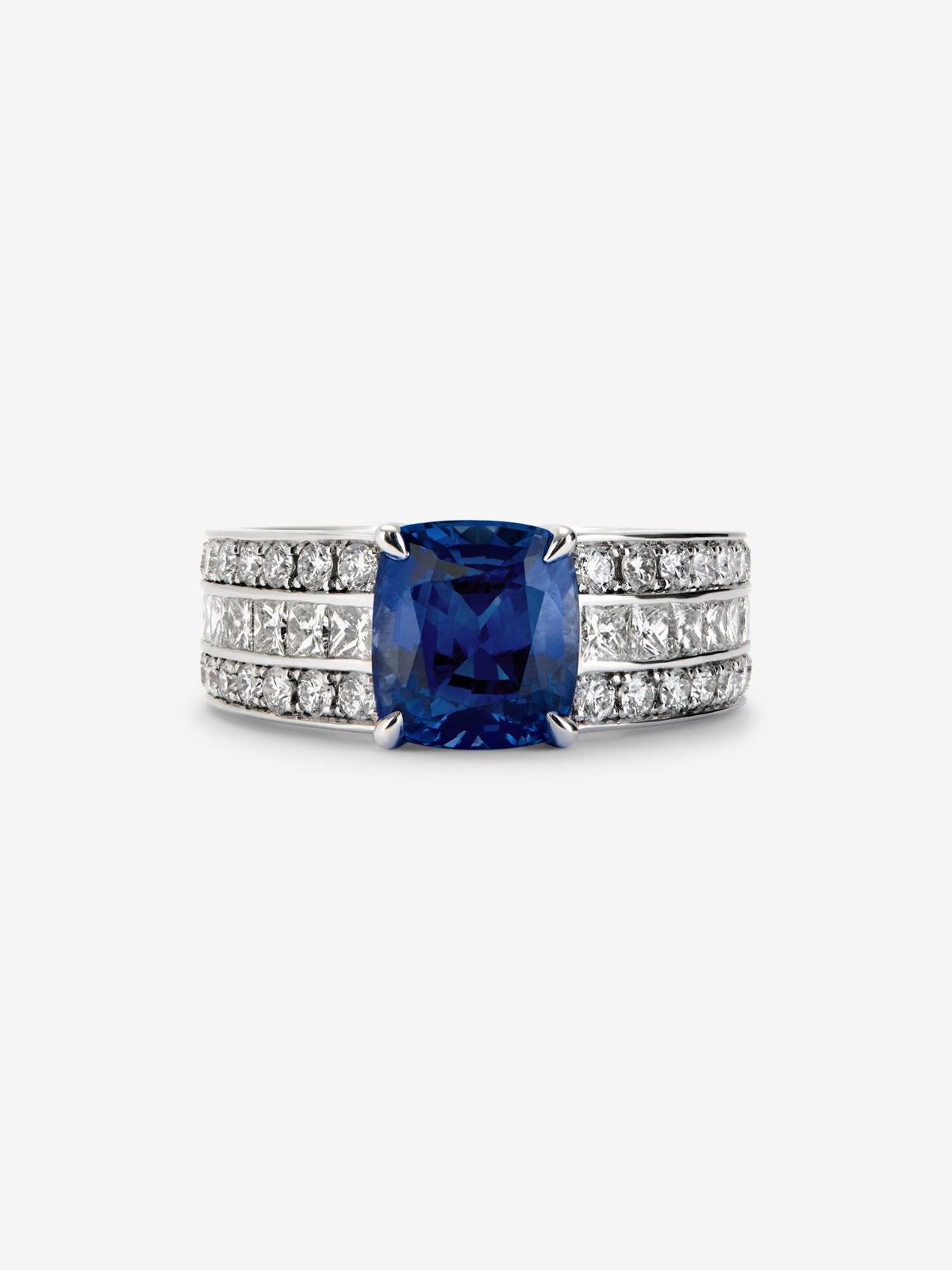 18K white gold ring with cushion-cut royal blue sapphire of 3.217 cts, 50 brilliant-cut diamonds with a total of 1.05 cts and 8 princess-cut diamonds with a total of 0.48 cts