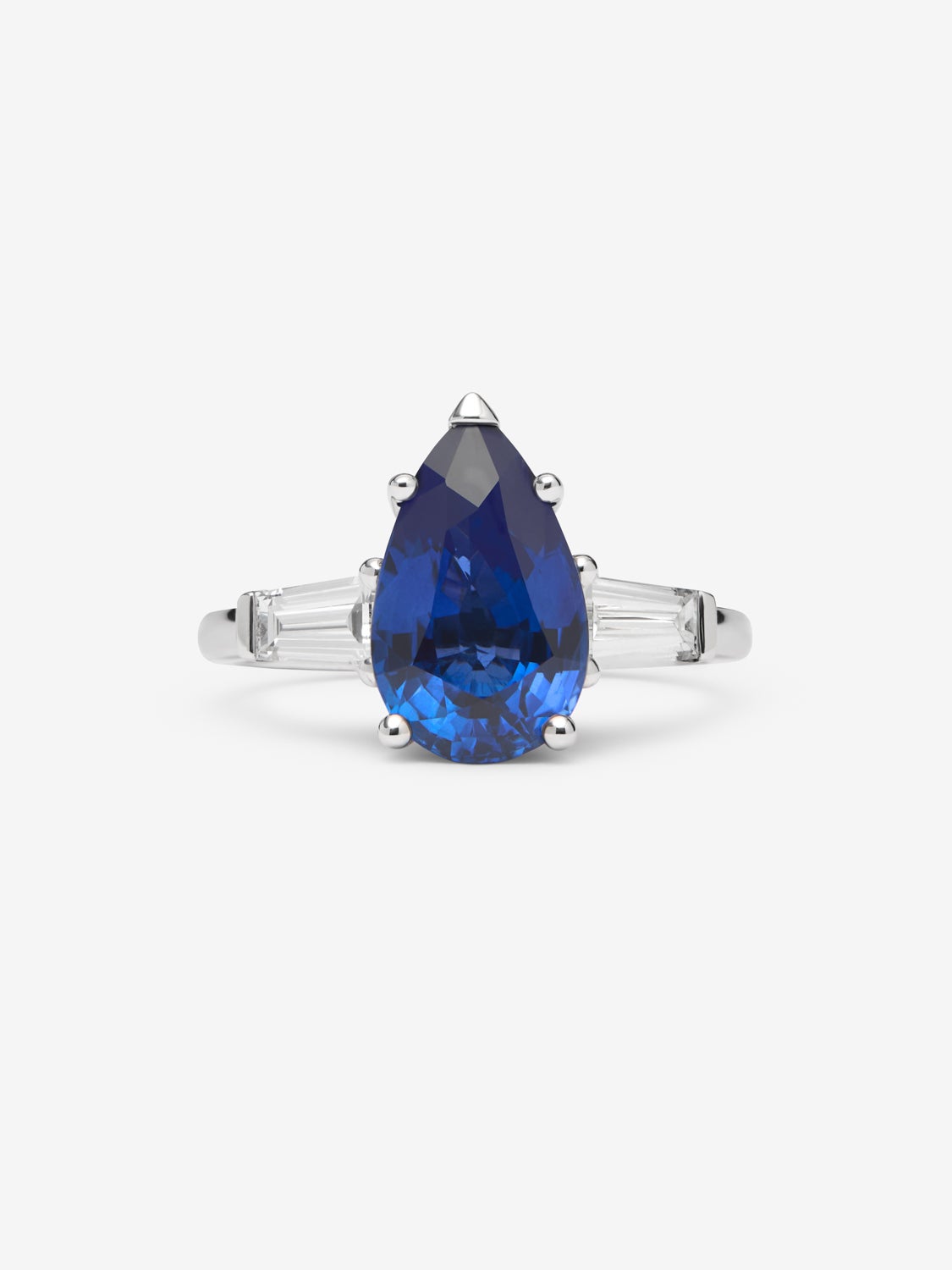 Anillo de oro blanco de 18K con zafiro azul royal en talla pera de 3,8 cts y 2 diamantes en talla trapecio con un total de 0,53 cts