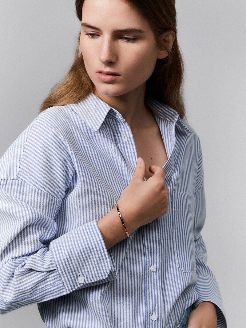 Thin rigid bracelet in 18K rose gold with diamonds. image number 0