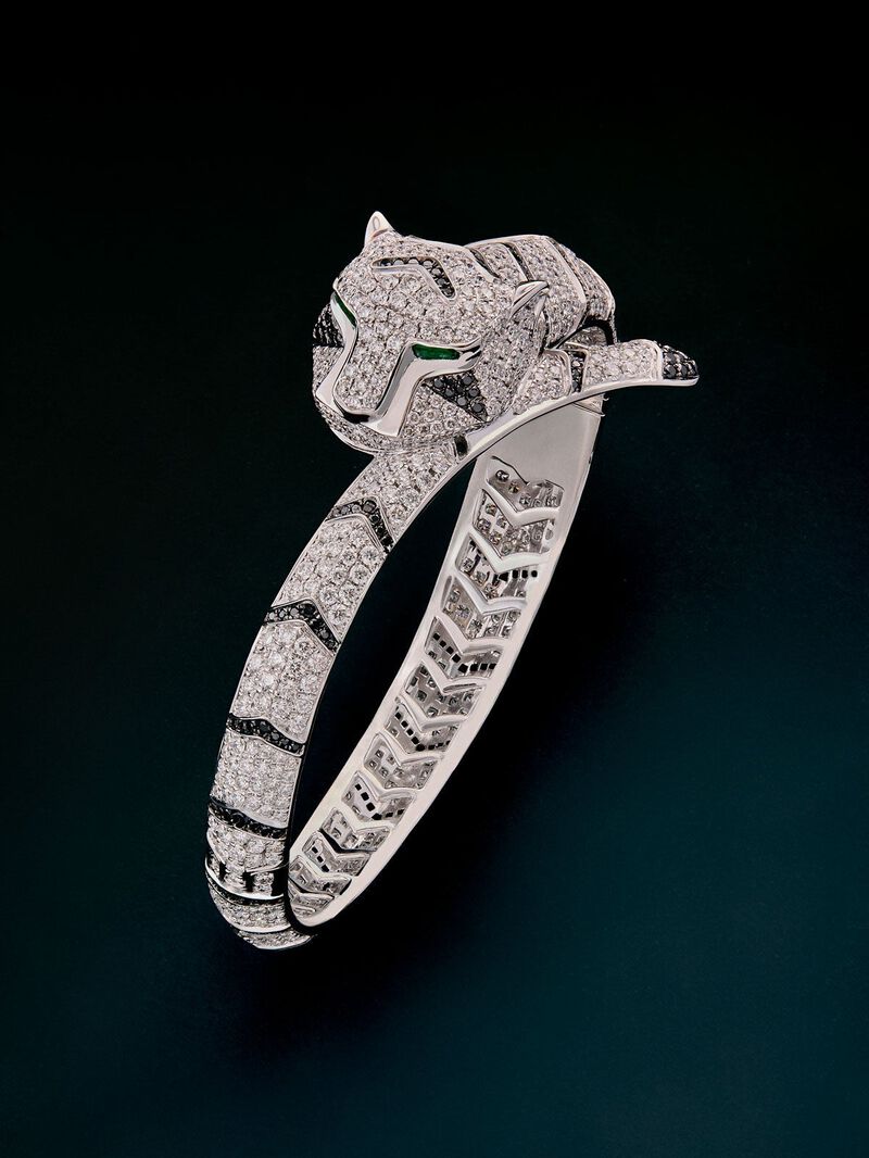 Rigid 18K white gold bracelet with 747 brilliant-cut white diamonds with a total of 8.17 cts, 241 brilliant-cut black diamonds with a total of 1.49 cts and 2 trapezoid-cut emeralds with a total of 0.13 tiger shaped cts image number 0