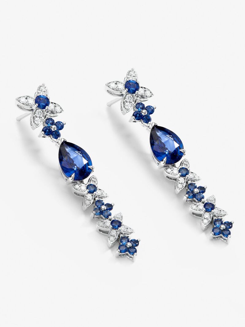 18k white gold earrings with royal blue sapps in pear size 4.05 cts, blue sapphires in bright size 1.27 cts and white diamonds in a bright size of 0.5 cts image number 2