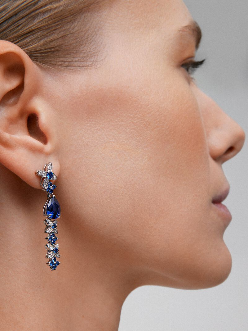 18k white gold earrings with royal blue sapps in pear size 4.05 cts, blue sapphires in bright size 1.27 cts and white diamonds in a bright size of 0.5 cts image number 1