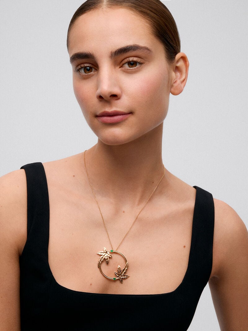 18K yellow gold pendant with two brilliant-cut emeralds totaling 0.29 cts, in a maple leaf design image number 1