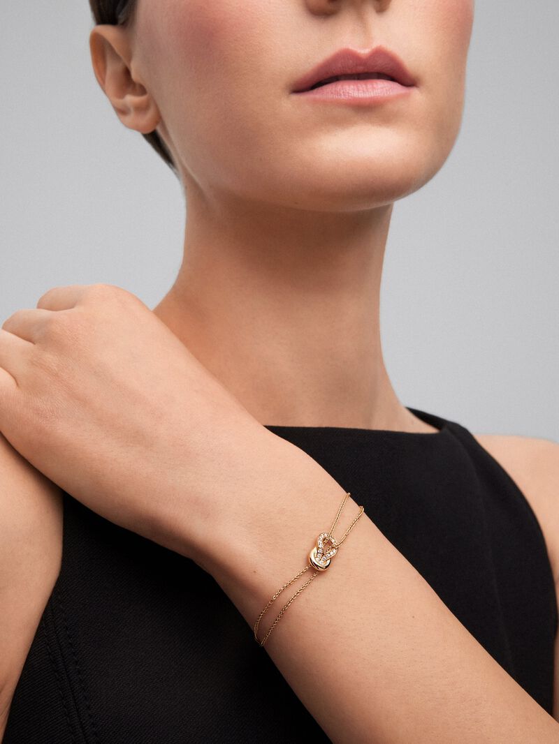 18K yellow gold bracelet with 17 brilliant-cut diamonds with a total of 0.15 cts and a knot shape image number 3