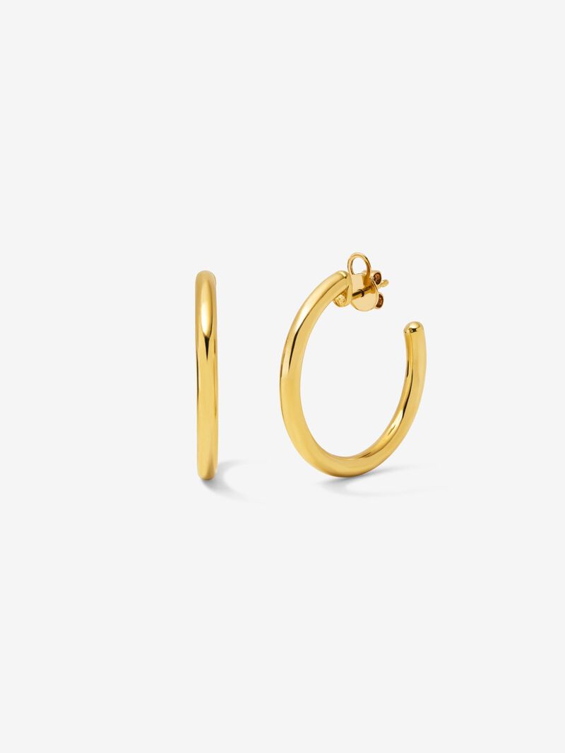 Medium smooth hoop earrings in 18K yellow gold. image number 0