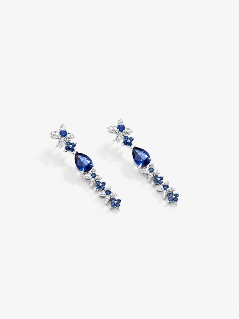 18k white gold earrings with royal blue sapps in pear size 4.05 cts, blue sapphires in bright size 1.27 cts and white diamonds in a bright size of 0.5 cts image number 2