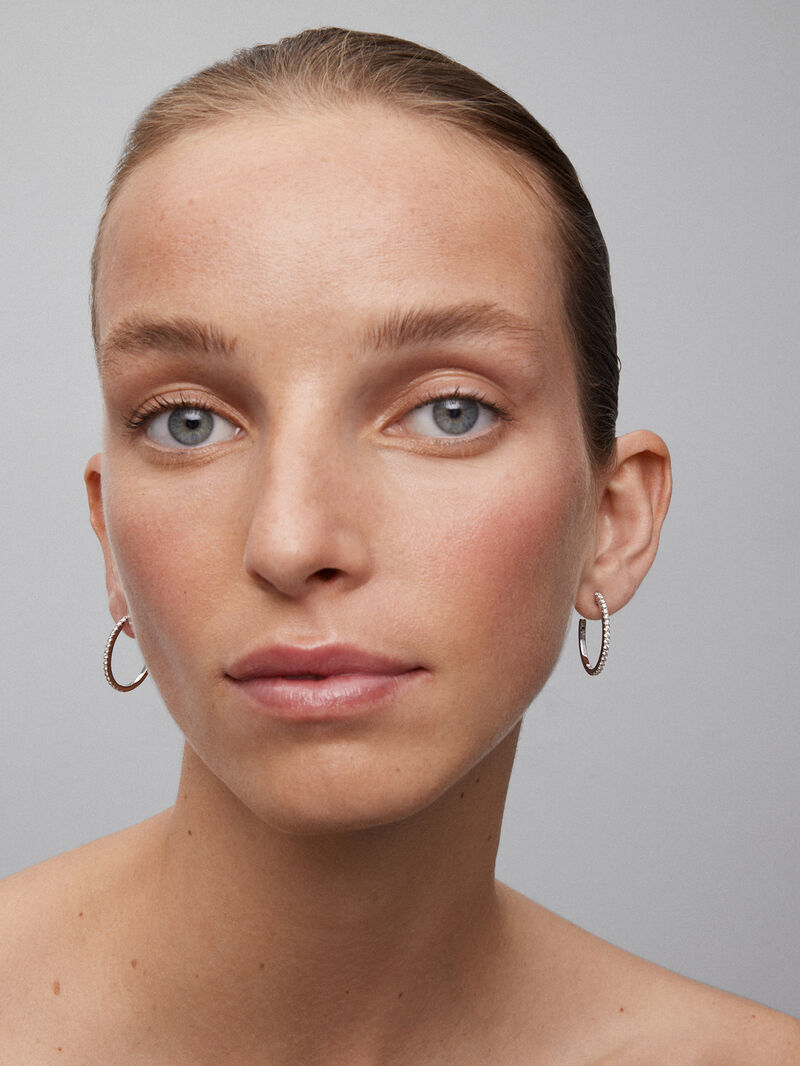 Thin hoop earrings made of 18K white gold with diamonds. image number 3