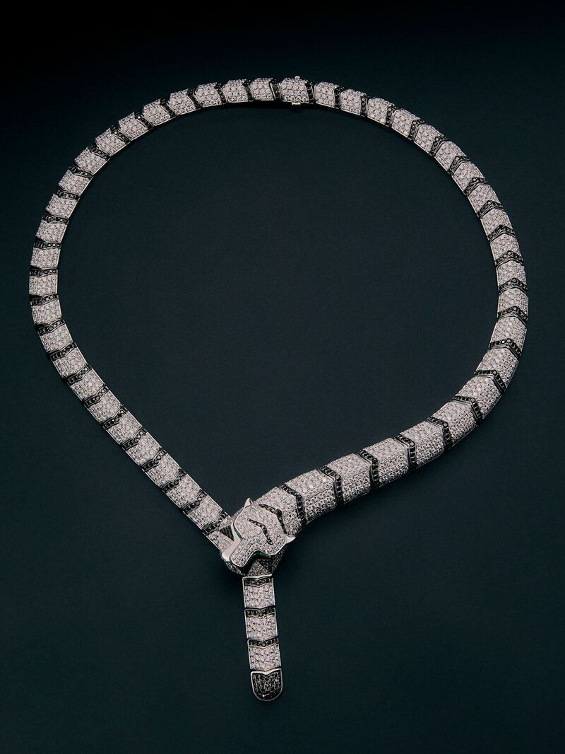 Rigid 18K white gold necklace with 1325 brilliant-cut white diamonds with a total of 19.09 cts, 453 brilliant-cut black diamonds with a total of 3.61 cts, and 2 trapezoid-cut emeralds with a total of 0. 13 cts in the shape of a tiger image number 0