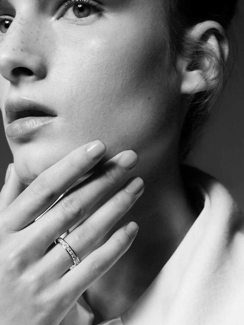 18K white gold half eternity engagement ring with princess cut diamonds on a rail. image number 3
