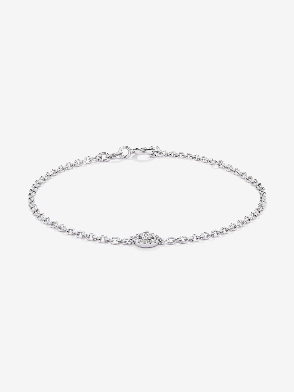 Pulsera cadena de oro blanco de 18K con diamante solitario y orla de diamantes
