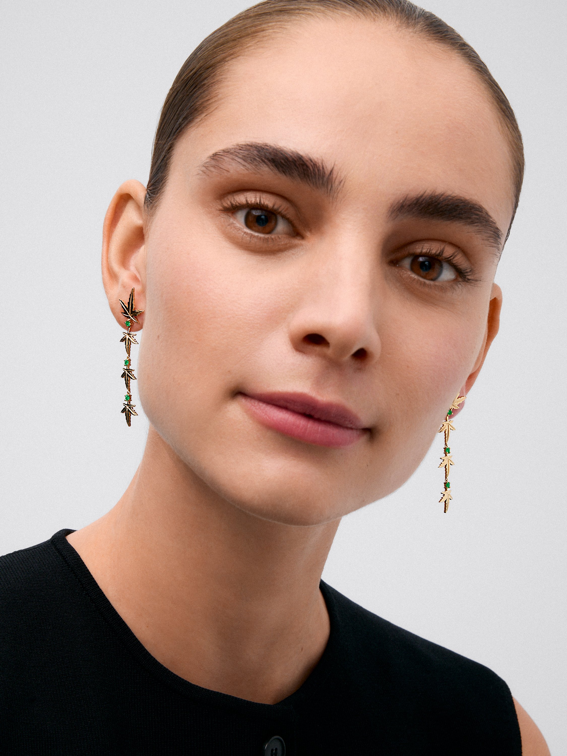 Pendientes de oro amarillo de 18K con 6 esmeraldas en talla brillante con un total de 0,37 cts y forma de hojas de arce