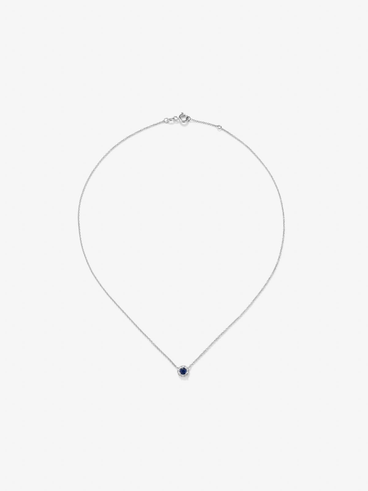 Colgante de oro blanco de 18K con un zafiro azul en talla brillante de 0,2 cts y 10 diamantes en talla brillante con un total de 0,05 cts