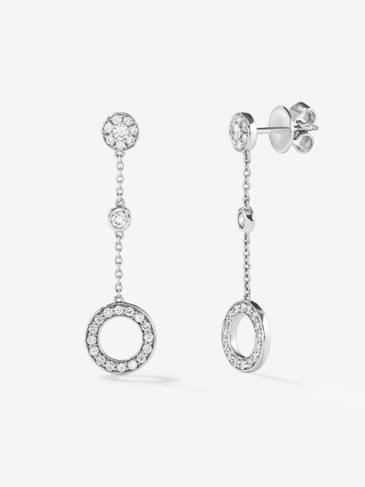 Long 18kt white gold chain earrings with circular diamond motifs.