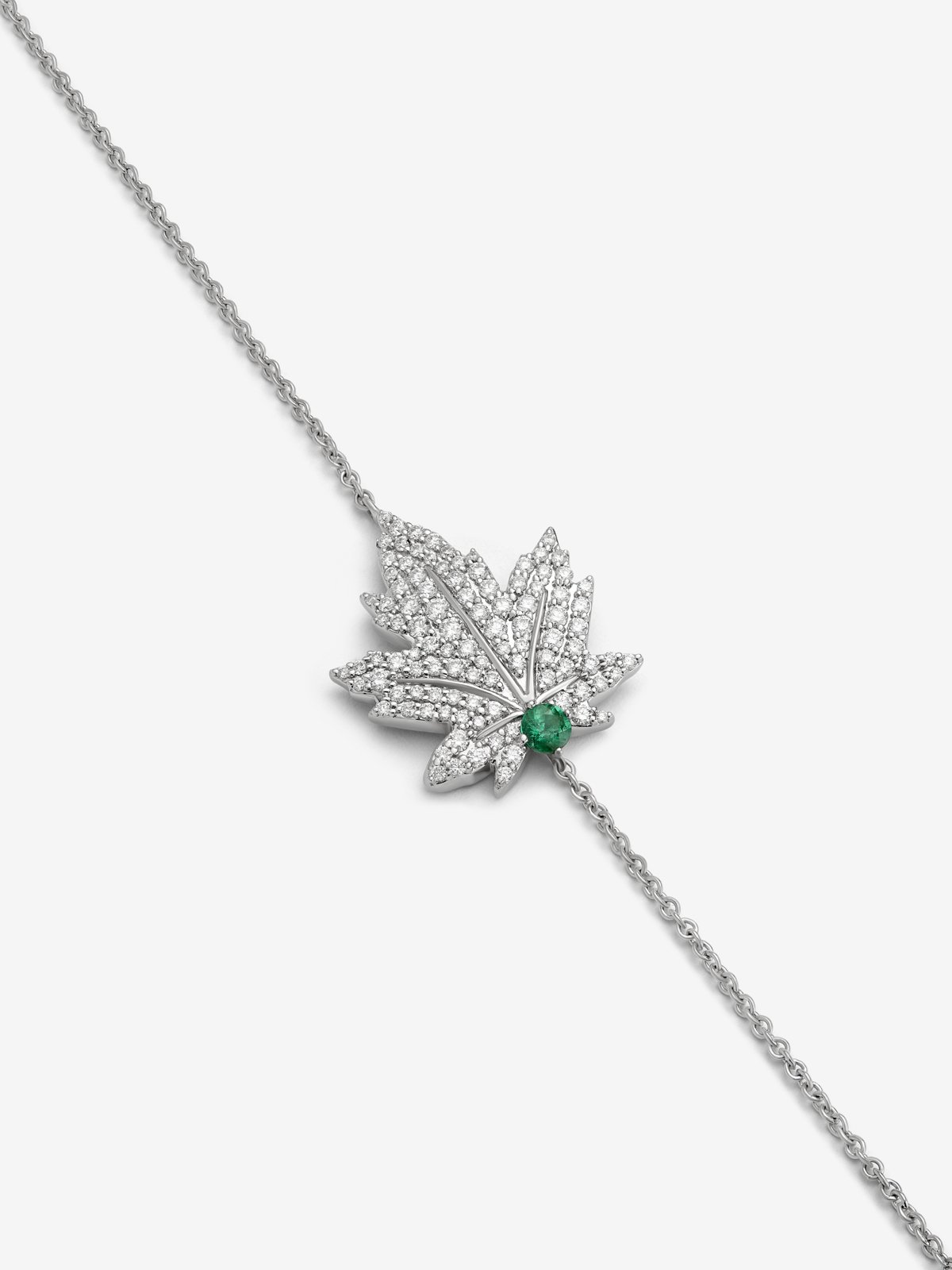 18K white gold bracelet with a 0.1 ct central emerald, diamond pavé, and a maple leaf design