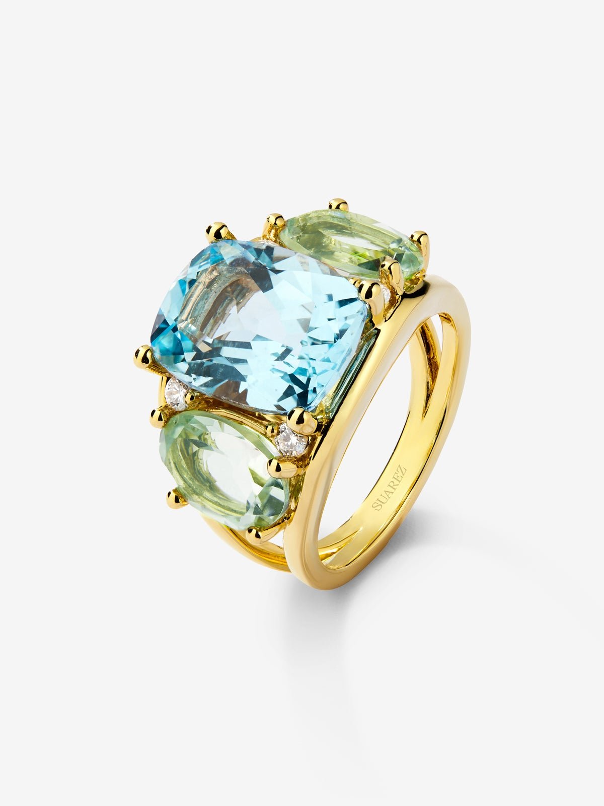 18K yellow gold ring with blue Sky Topacio in 5.5 cts Cushion size, green -sized icatists of 4.65 cts and white diamonds in a brilliant size of 0.15 cts